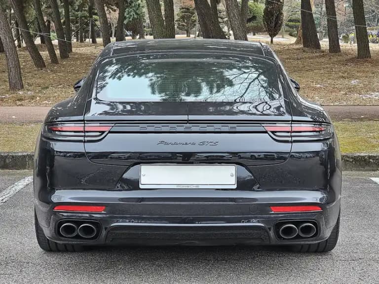Black Porsche Panamera GTS from the rear showing the quad exhaust tips and diffuser