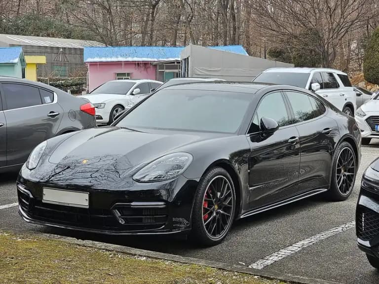Black Porsche Panamera GTS in profile showing the lowered stance and long fastback roofline