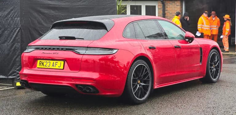Red Porsche Panamera GTS Sport Turismo, rear three-quarter view showing the wagon roofline