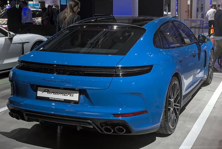 Blue Porsche Panamera GTS rear three-quarter view with quad tailpipes and Panamera GTS script