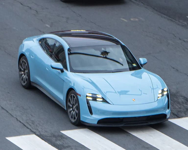 Light blue Porsche Taycan 4S sedan front three-quarter view