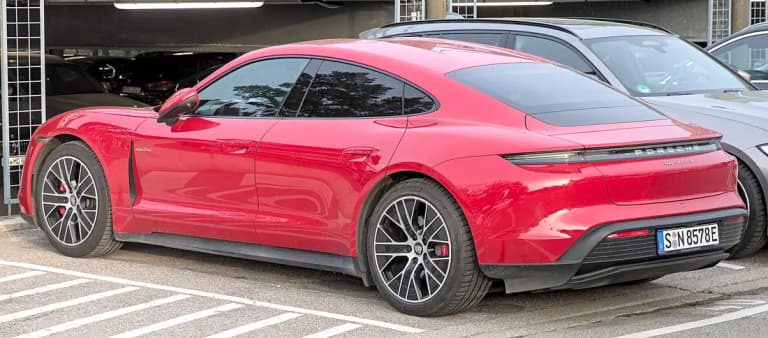 Red Porsche Taycan 4S sedan rear three-quarter view with 4S badge