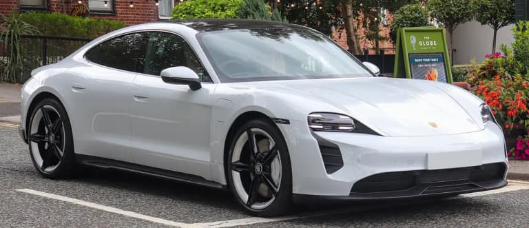 White Porsche Taycan 4S sedan parked on a street, front three-quarter view