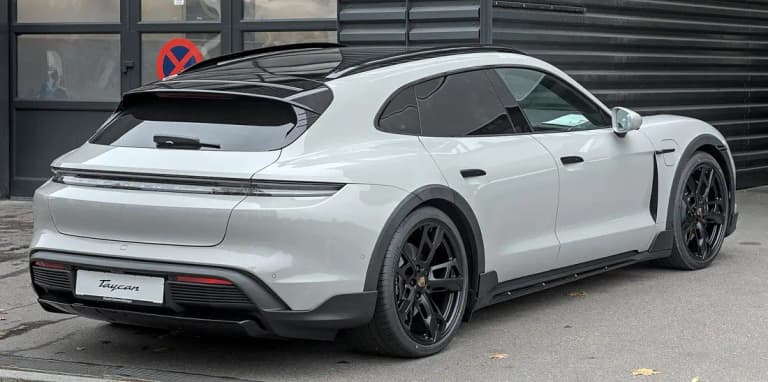 Grey Porsche Taycan Cross Turismo rear three-quarter view with the raised wagon body
