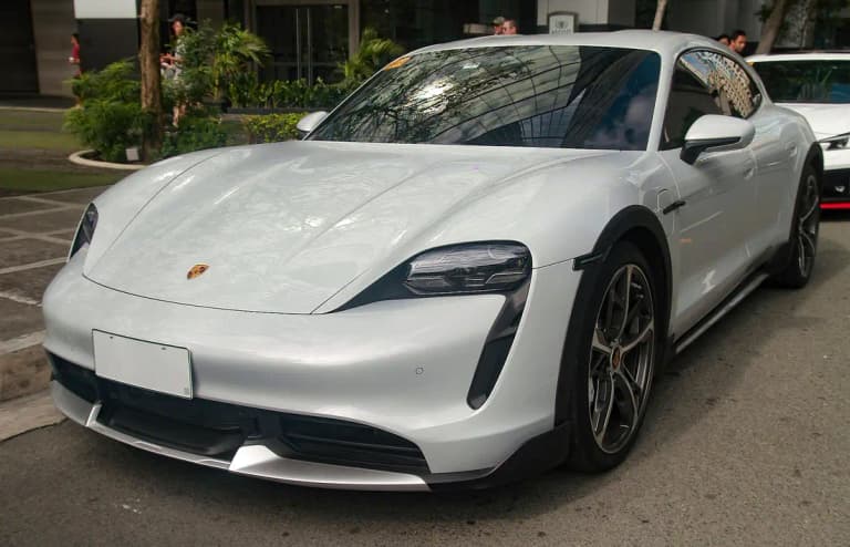 Grey Porsche Taycan Turbo Cross Turismo front three-quarter view outdoors