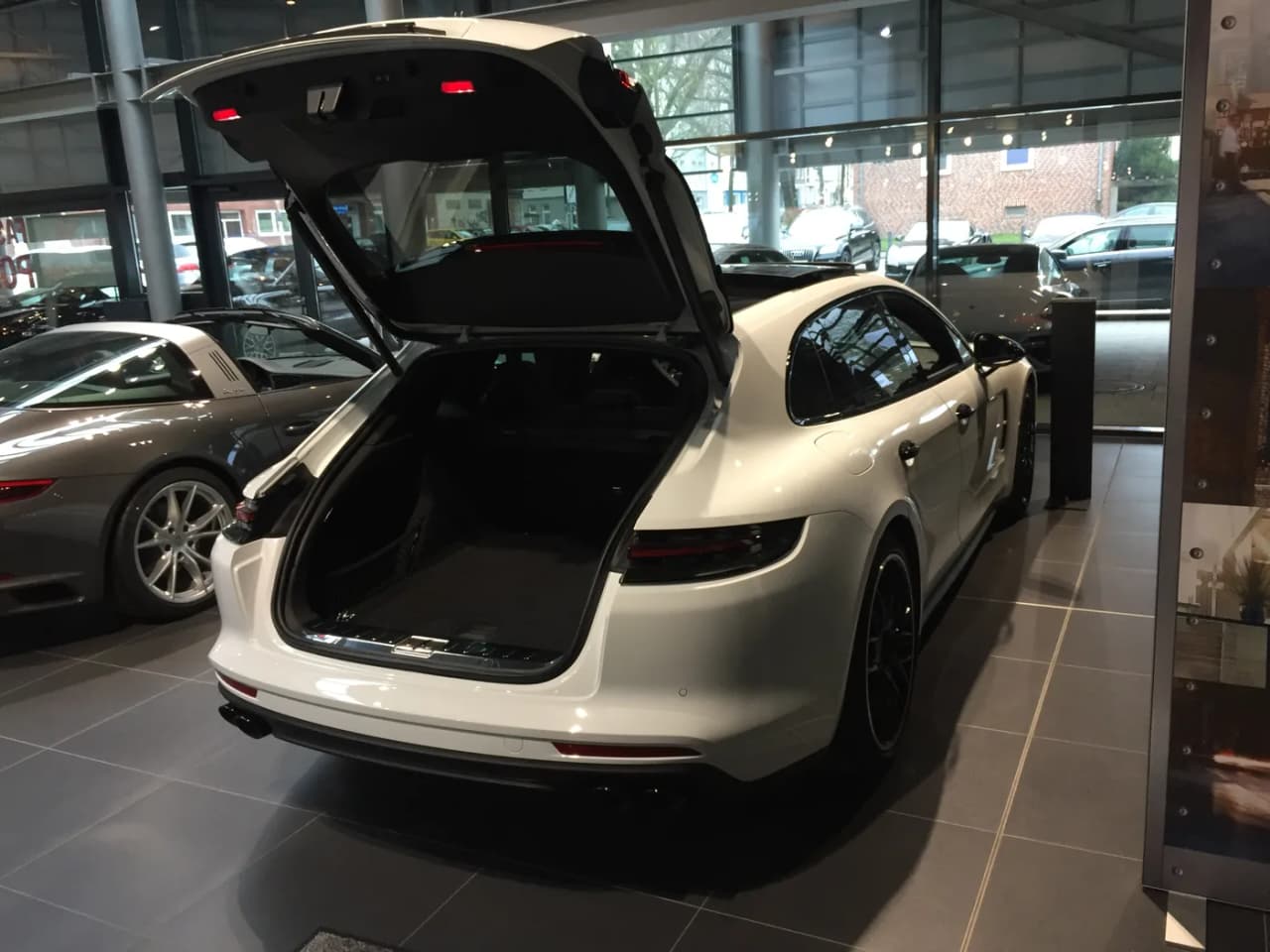 Porsche Panamera Sport Turismo with power tailgate open showing the low, flat cargo area