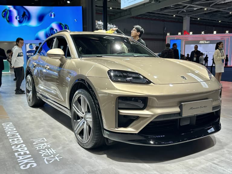 Second-generation all-electric Porsche Macan Turbo viewed from the front three-quarter angle.