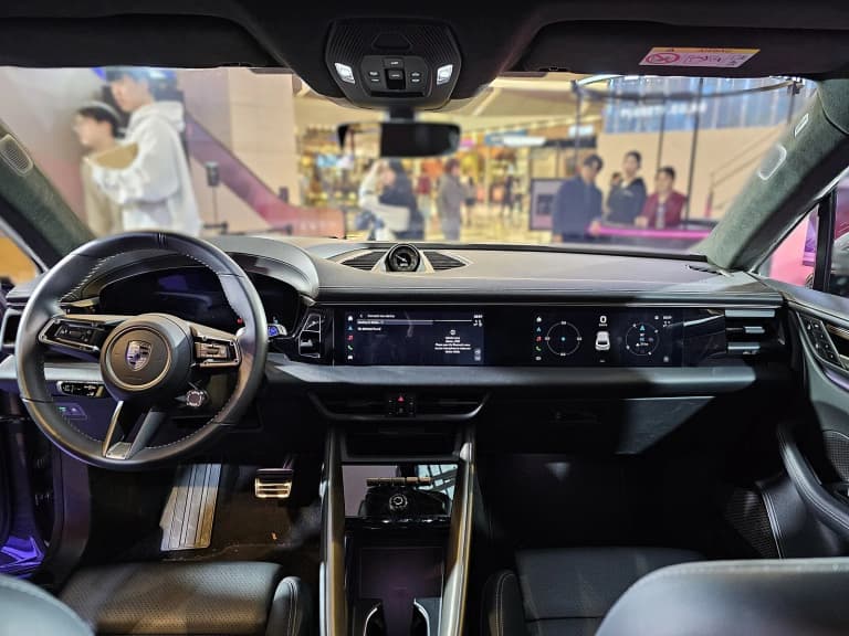 Dashboard and screens of an all-electric Porsche Macan Turbo.