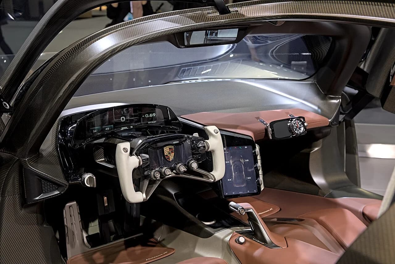 Porsche Mission X interior with open-top steering wheel and driver-focused cockpit