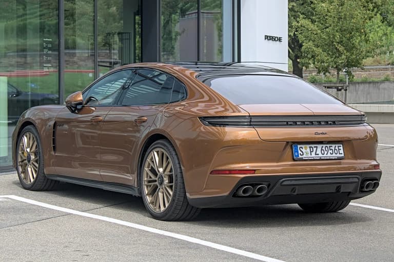 Rear of a bronze third-generation Porsche Panamera Turbo E-Hybrid, with its full-width light bar.