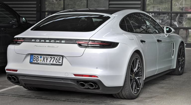 White Porsche 971 Panamera Turbo S E-Hybrid photographed from the rear.