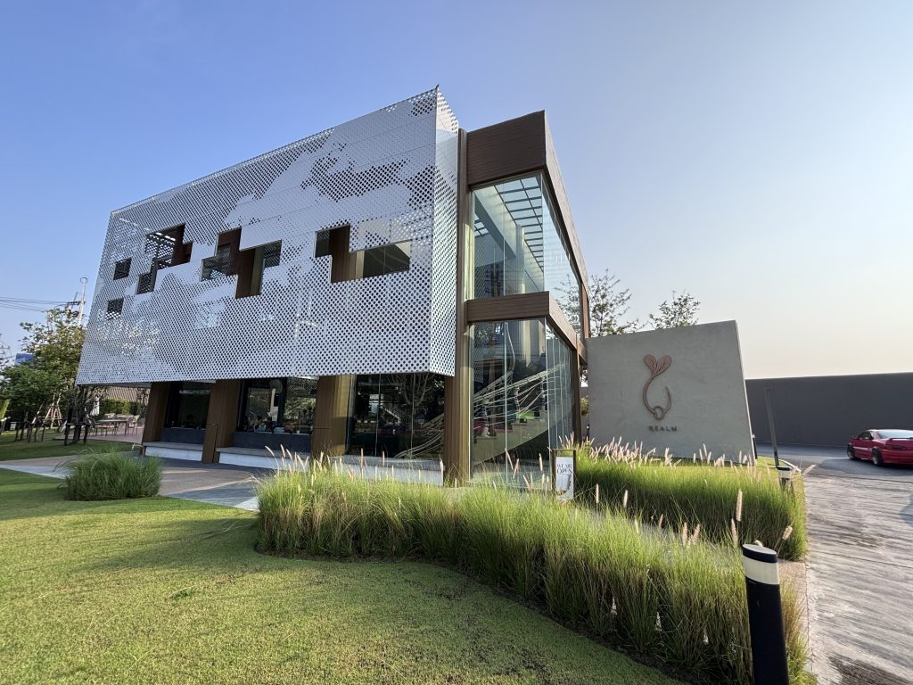 Realm Bangkok's perforated metal and glass exterior with the Realm sign