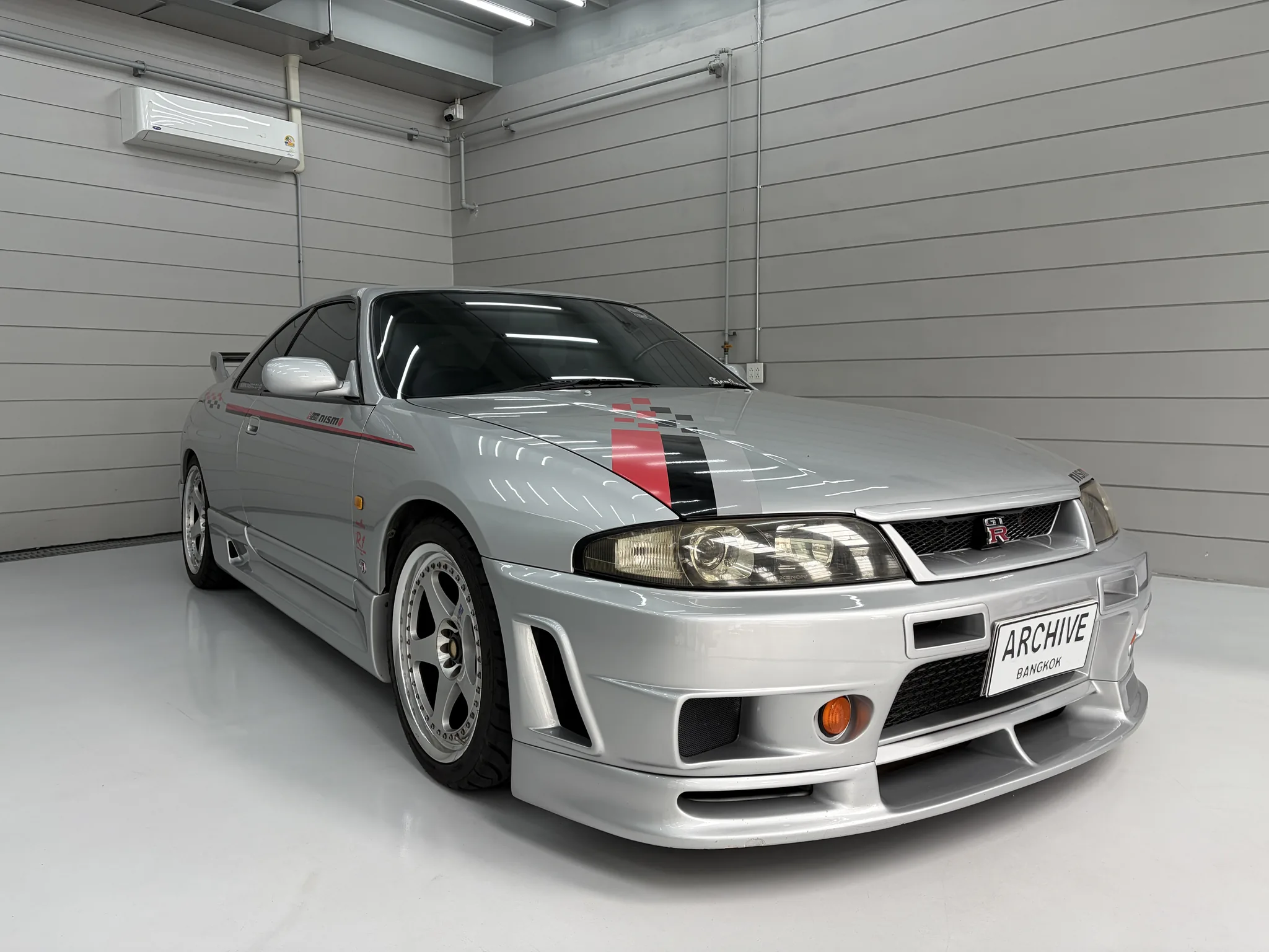 Silver sports car inside the Archive Coffee garage