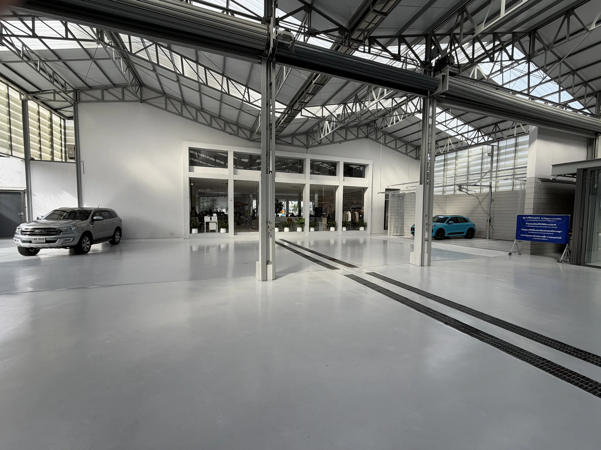 Open Archive Coffee garage with parked cars