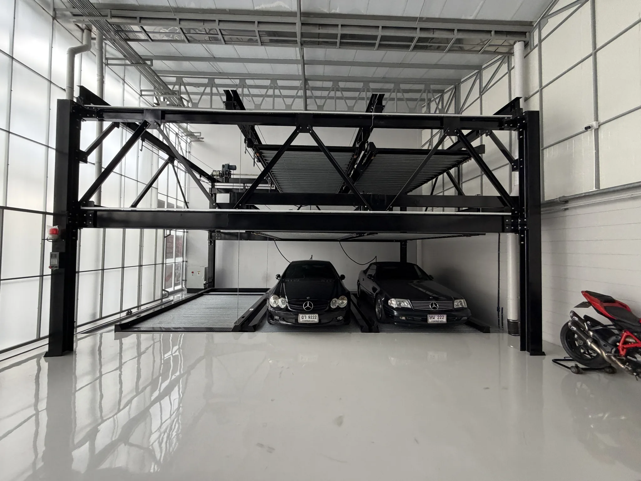 Cars beneath the Archive Coffee garage lift