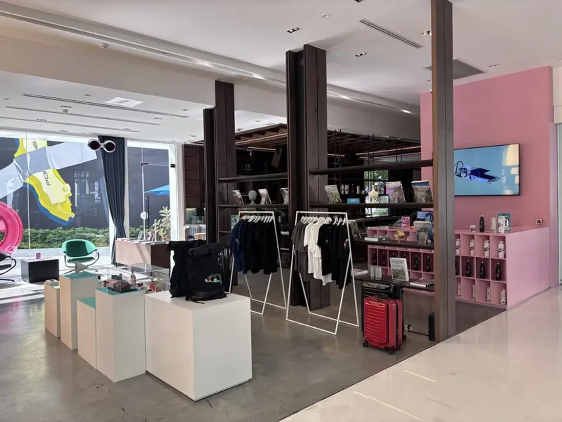 Porsche Lifestyle Boutique corner at Curvistan Bangkok with apparel racks and Porsche Design luggage
