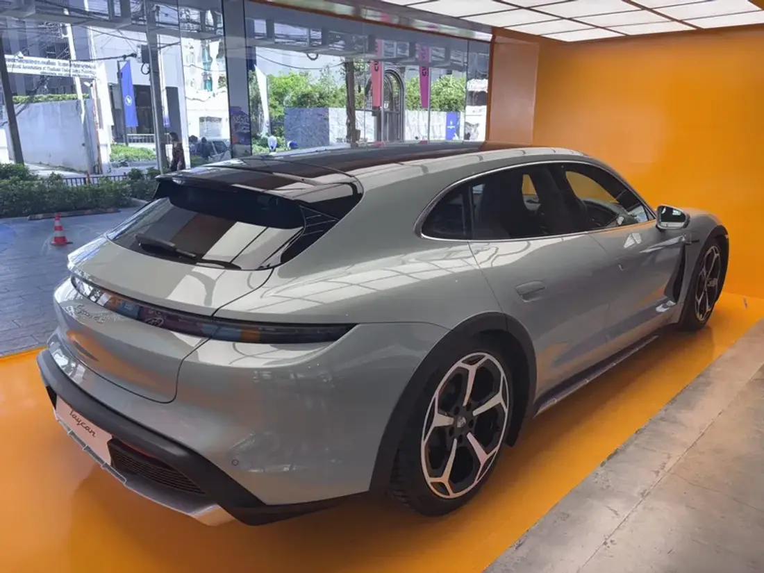 Porsche Taycan Cross Turismo displayed inside Curvistan Bangkok on the orange gallery floor