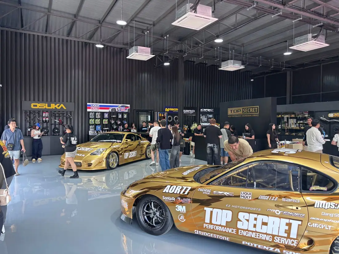Gold Top Secret Toyota Supra and 350Z inside the Bangkok showroom with brand display walls